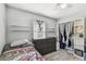 Serene bedroom with wood-look floors, storage shelves, and ample closet space for organized living at 6914 N Ola Ave, Tampa, FL 33604