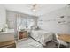 Bedroom with wood-look floors, ceiling fan, and modern decor at 6914 N Ola Ave, Tampa, FL 33604