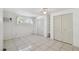 Bedroom features tile floors, closet space, and a window at 6914 N Ola Ave, Tampa, FL 33604