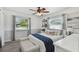 Inviting bedroom with a ceiling fan, natural light, and a stylish accent bench for added comfort at 6914 N Ola Ave, Tampa, FL 33604