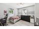 Cozy bedroom with wood-look floors, ceiling fan, and lots of natural light from two windows at 6914 N Ola Ave, Tampa, FL 33604