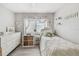 Cozy bedroom featuring soft natural light, wood-look floors, and a comfortable bed at 6914 N Ola Ave, Tampa, FL 33604