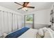 Comfortable bedroom with a ceiling fan, natural light, and elegant curtains for privacy and style at 6914 N Ola Ave, Tampa, FL 33604