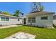 Charming home with well-manicured lawn and tidy landscaping at 6914 N Ola Ave, Tampa, FL 33604