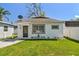 Charming single-story home with neat landscaping and a well-maintained lawn at 6914 N Ola Ave, Tampa, FL 33604