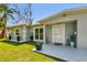 Inviting front porch features modern potted plants and stylish accents leading to the front door at 6914 N Ola Ave, Tampa, FL 33604
