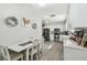 Bright, open kitchen with white cabinets, stainless steel appliances, and an adjacent dining area at 6914 N Ola Ave, Tampa, FL 33604