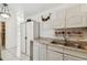This kitchen boasts ample counter space, white cabinets, and a window view at 6914 N Ola Ave, Tampa, FL 33604