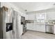 Bright kitchen featuring stainless steel appliances, white cabinets, and modern finishes at 6914 N Ola Ave, Tampa, FL 33604