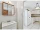 This kitchenette boasts white cabinets and a sleek white sink at 6914 N Ola Ave, Tampa, FL 33604