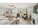 Bright living room with a fireplace, comfortable seating, and ample natural light at 6914 N Ola Ave, Tampa, FL 33604