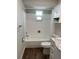 Bathroom features a shower/tub combo, matching toilet, and vanity with marble countertop at 10627 Mira Vista Dr, Port Richey, FL 34668