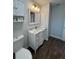 Bathroom boasts a sleek white vanity, decorative mirror, and tiled flooring at 10627 Mira Vista Dr, Port Richey, FL 34668