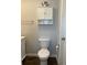 Bathroom view includes a toilet with a matching storage cabinet and towel bar at 10627 Mira Vista Dr, Port Richey, FL 34668