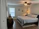 Bedroom featuring a comfortable bed, ceiling fan, and closet space at 10627 Mira Vista Dr, Port Richey, FL 34668
