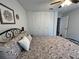 Bedroom featuring a decorative bed, neutral walls, white closet doors, and a ceiling fan at 10627 Mira Vista Dr, Port Richey, FL 34668