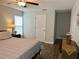 Bedroom view with a bed, window, and access to additional rooms at 10627 Mira Vista Dr, Port Richey, FL 34668