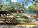 Bocce ball court in outdoor common area with benches and beautiful landscaping create a relaxing experience at 10627 Mira Vista Dr, Port Richey, FL 34668