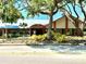 A community building with landscaping and mature trees and shrubbery in a well-maintained, serene setting at 10627 Mira Vista Dr, Port Richey, FL 34668