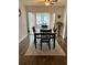 Sun-filled dining area features wood floors, a ceiling fan and sliding glass doors that provide access to the lanai at 10627 Mira Vista Dr, Port Richey, FL 34668