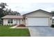 Charming single-story home features a well-manicured lawn, attached garage and inviting front entrance at 10627 Mira Vista Dr, Port Richey, FL 34668