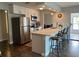 Modern kitchen features stainless steel appliances, breakfast bar with seating and a beautiful stone countertop at 10627 Mira Vista Dr, Port Richey, FL 34668