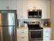 Efficiently designed kitchen has stainless steel appliances, white cabinets and a modern design for style and function at 10627 Mira Vista Dr, Port Richey, FL 34668
