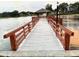 Picturesque lakeside pier with a covered gazebo provides residents a serene spot to enjoy nature and sunset views at 10627 Mira Vista Dr, Port Richey, FL 34668