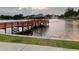 Charming pier with gazebo offers stunning lake views and sunset scenery for residents enjoyment and relaxation at 10627 Mira Vista Dr, Port Richey, FL 34668