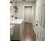 Bright laundry room featuring a modern washer, dryer and shelving for storage with wood-look tile flooring at 10627 Mira Vista Dr, Port Richey, FL 34668