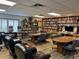 Library features shelves filled with books and DVDs and comfortable seating for reading at 10627 Mira Vista Dr, Port Richey, FL 34668