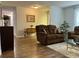A cozy living room boasts hardwood floors, comfortable seating, and neutral décor, creating a relaxing atmosphere at 10627 Mira Vista Dr, Port Richey, FL 34668