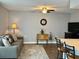 Cozy living room featuring a sofa, rug, side table, and adjacent breakfast bar at 10627 Mira Vista Dr, Port Richey, FL 34668