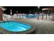 Inviting community pool area with ample seating, well-lit and perfect for evening relaxation in a quiet neighborhood at 10627 Mira Vista Dr, Port Richey, FL 34668