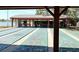 Shuffleboard courts under a covered structure by the lake, perfect for outdoor recreation and community gatherings at 10627 Mira Vista Dr, Port Richey, FL 34668
