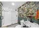 Bathroom featuring walk-in shower and tropical wallpaper at 10716 Donbrese Ave, Tampa, FL 33615
