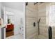Modern bathroom featuring a sleek glass shower with tile surround and contrasting black fixtures at 10716 Donbrese Ave, Tampa, FL 33615