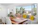 Dining area with large bay window, bench seating with pillows, and wood floors at 10716 Donbrese Ave, Tampa, FL 33615