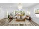 This dining area features light wood floors, lots of light and a unique light fixture at 10716 Donbrese Ave, Tampa, FL 33615
