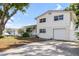 Exterior shot of home with spacious driveway, manicured lawn and beautiful front door at 10716 Donbrese Ave, Tampa, FL 33615