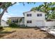 Charming two-story home featuring a manicured lawn, palm trees, and a front-facing garage at 10716 Donbrese Ave, Tampa, FL 33615
