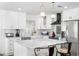 White kitchen with stainless steel appliances, a marble island, and white subway tile backsplash at 10716 Donbrese Ave, Tampa, FL 33615