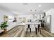Kitchen with white cabinets, stainless steel appliances, a large island, and pendant lighting at 10716 Donbrese Ave, Tampa, FL 33615