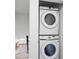 Convenient laundry area with stacked washer and dryer, situated near the dining room at 10716 Donbrese Ave, Tampa, FL 33615