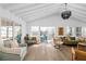 Bright living room with beamed ceilings and sliding glass doors to the pool at 10716 Donbrese Ave, Tampa, FL 33615