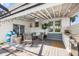 Inviting outdoor patio with grill, string lights, comfortable seating, and garden views at 10716 Donbrese Ave, Tampa, FL 33615