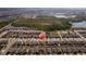 An aerial shot showcasing a planned residential community with beautiful landscaping, adjacent to a serene lake and conservation area at 1102 Wynnmere Walk Ave, Ruskin, FL 33570