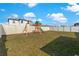 Fenced backyard featuring a swing set and playground, providing an ideal space for outdoor activities at 1102 Wynnmere Walk Ave, Ruskin, FL 33570