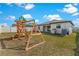 Wide backyard showcasing a playground, lawn, and patio area, perfect for outdoor activities at 1102 Wynnmere Walk Ave, Ruskin, FL 33570