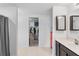 Bathroom with a vanity, tiled floors, and a walk-in closet for ample storage space at 1102 Wynnmere Walk Ave, Ruskin, FL 33570